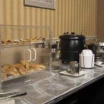 breakfast buffet setup with pastries and oatmeal