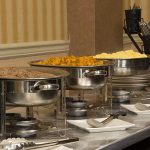 breakfast buffet setup with sausage, potatoes and scrambled eggs