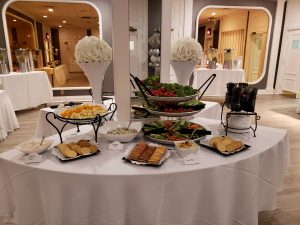 buffet including vegetable platter, crackers, and assorted cheeses